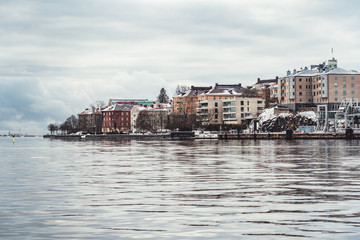 Naklejka premium Older apartment houses at the coast of Helsinki Finland on a cold winter day