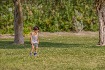 A lost little boy begins to cry and panic for his mother at the park.