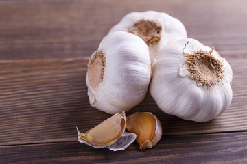 Garlic Cloves and Garlic Bulb on vintage wood background