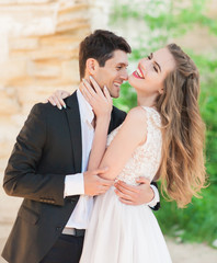 Fototapeta premium Bride and groom at wedding ceremony by the old cathedral