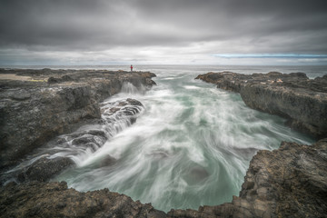 Man watching raging ocean waves of Oregon coast