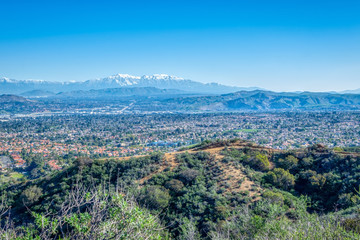 Winter snow in the distance with forest and city 
