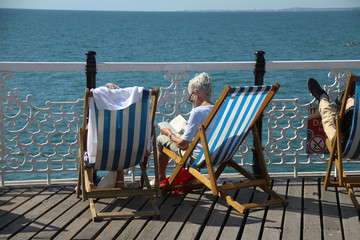 People bask in the sun on the Brighton Palace Pier - UK