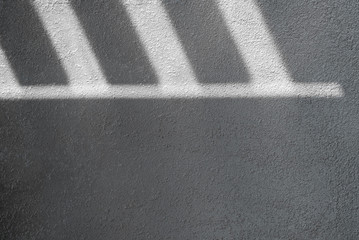 Shadow and light through blinds window on tiled wall. Abstract form morning light and shadow on the...