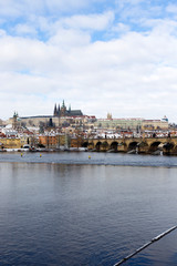 Fototapeta premium Snowy Prague Lesser Town with Prague Castle and Charles Bridge, Czech republic
