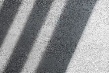 Shadow and light through blinds window on tiled wall. Abstract form morning light and shadow on the...