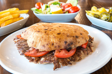Turkish Doner Kebab, Shawarma or Gyros. Traditional Turkish Doner Kebab meat sandwich, shawarma or gyros in restaurant	