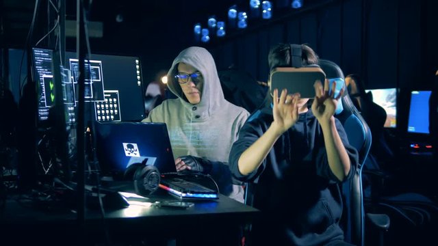 People hack system, using VR glasses, close up.