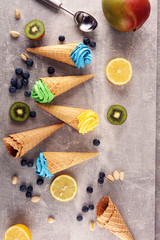 Fototapeta na wymiar Vanilla frozen yogurt or colorful soft ice cream in waffle cone.