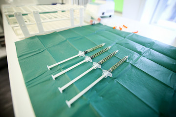 Details with syringes holding blood and blood plasma