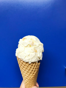 Hokey pokey ice cream on waffle cone famous New Zealand ice cream with vanilla flavor and small solid lumps of honeycomb toffee made from brown sugar syrup isolated hokey pokey ice cream 