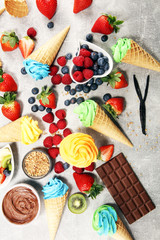 Fototapeta na wymiar Vanilla frozen yogurt or colorful soft ice cream in waffle cone.