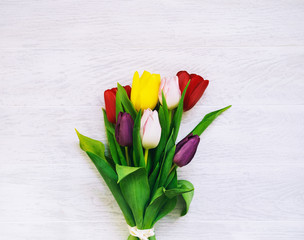 Spring tulips flowers on wooden white background