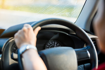 Naklejka premium man fast driving a car on the way in the morning