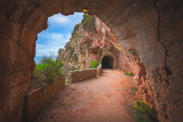 Tunnel cut out in the seaside rocky cliffs