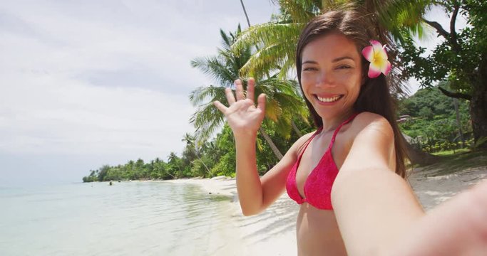 Social Media Selfie Video - Woman In Bikini Taking Photo With Phone On Beach. Sexy beaautiful woman is enjoying vacation at beach paradise with palm trees using smartphone. Slow Motion.
