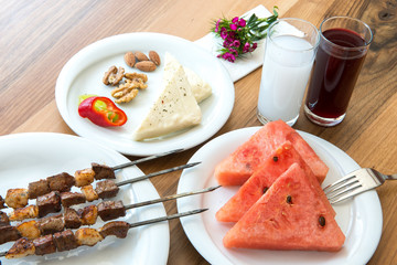 Traditional Turkish Adana Kebab or kebap meat food, raki and salgam in Turkish Restaurant with salad