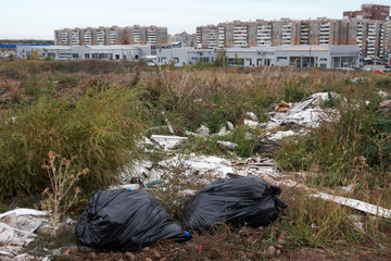 Illegal city dump in the wasteland in the dry grass