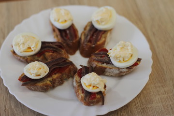 home made spanish traditional snack pintxos with anchovy and egg 