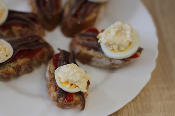 home made spanish traditional snack pintxos with anchovy and egg 