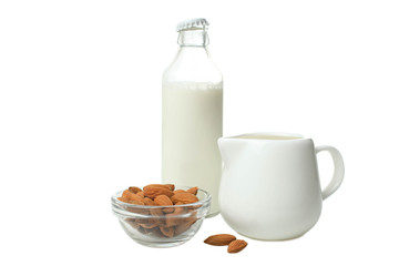 Glass bottle with milk, milk jug and almond nuts