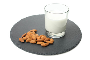 Glass cup of milk and almond nuts