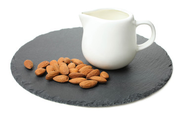 white milk jug and almond nuts
