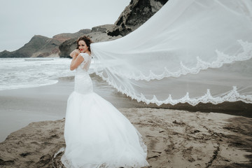 Fototapeta na wymiar The bridal beautifully veils evolving in the wind at the coast.