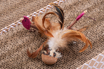 Leaps & Bounds Ball with Feather Cat Toy on reversible cat scratcher made of 100% recycled cardboard. Cat Toys for Scratching and Exercise.