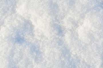 White crystals of snow on flat surface. Texture background