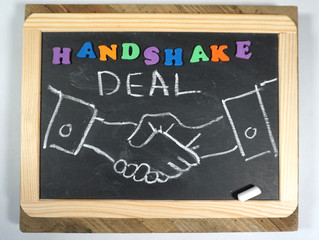 Business Handshake on chalkboard