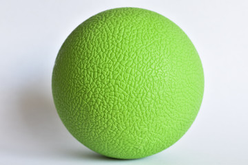 Green lacrosse ball closeup with rough surface pattern