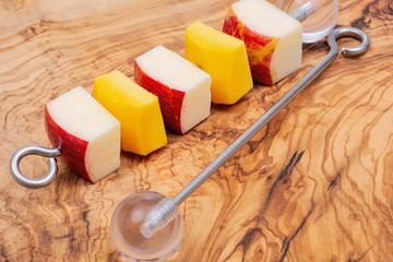 Apple and mango pieces on Bird Kabob Stainless Steel Skewer with threaded pointed tip to screw into solid acrylic ball. Parrot Fruit Vegetable Food Stick Holder with closed loop at bottom.