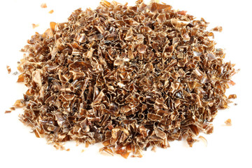 Small pieces of cut brown plastic bottles on white paper