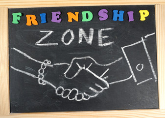 Friendship zone handshake on chalkboard