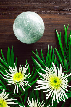 Green Aventurine Sphere with White Chrysanthemums and Foliage