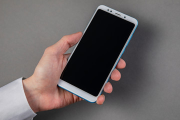 Man's hand holding mobile phone