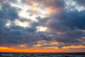 Fototapeta premium beautiful sunset view over the sea with bright colorful clouds