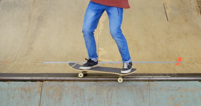 High angle view of young man doing skateboard trick on skateboard ramp at skateboard court 4k