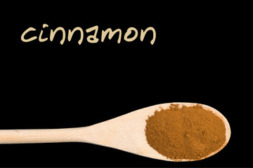 cinnamon on wooden spoon isolated on black background.Latin name Cinnamomum verum