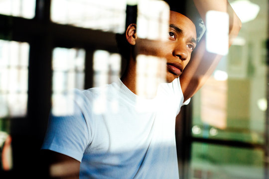 Portrait Of A Young Millennial Man Looking Out The Window