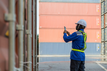 Foreman control loading Containers box from Cargo freight ship for logistics import export background.