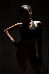 Asian Tan Skin Fitness woman exercise stretch arms boxing weight punch in Dark background, studio lighting gradient gray top light shadow low exposure copy space, concept Woman Can Do Sport 6 packs