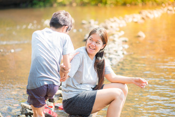 Family travelling at waterfall in the forest happy together