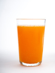 Glass of orange juice on white