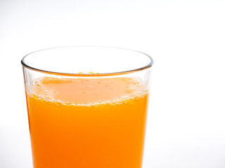 Glass of orange juice on white