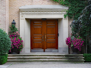 Fototapeta na wymiar front door of large expensive house with elegant wooden double front door