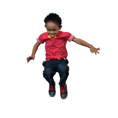 Cute emotional joyful little boy jumping on white background.