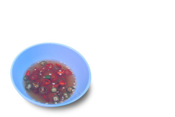 slice chili mixed fish sauce in blue cup isolated on white background.side dish of Thai food.