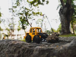 tractor  toy on the ground in the garden